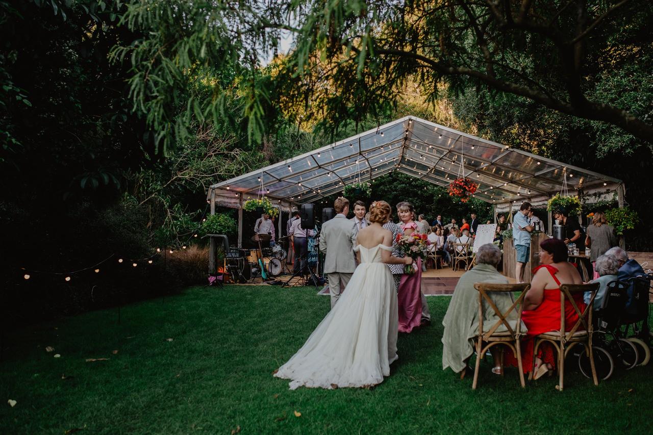 Outdoor wedding reception in green clearing in forest