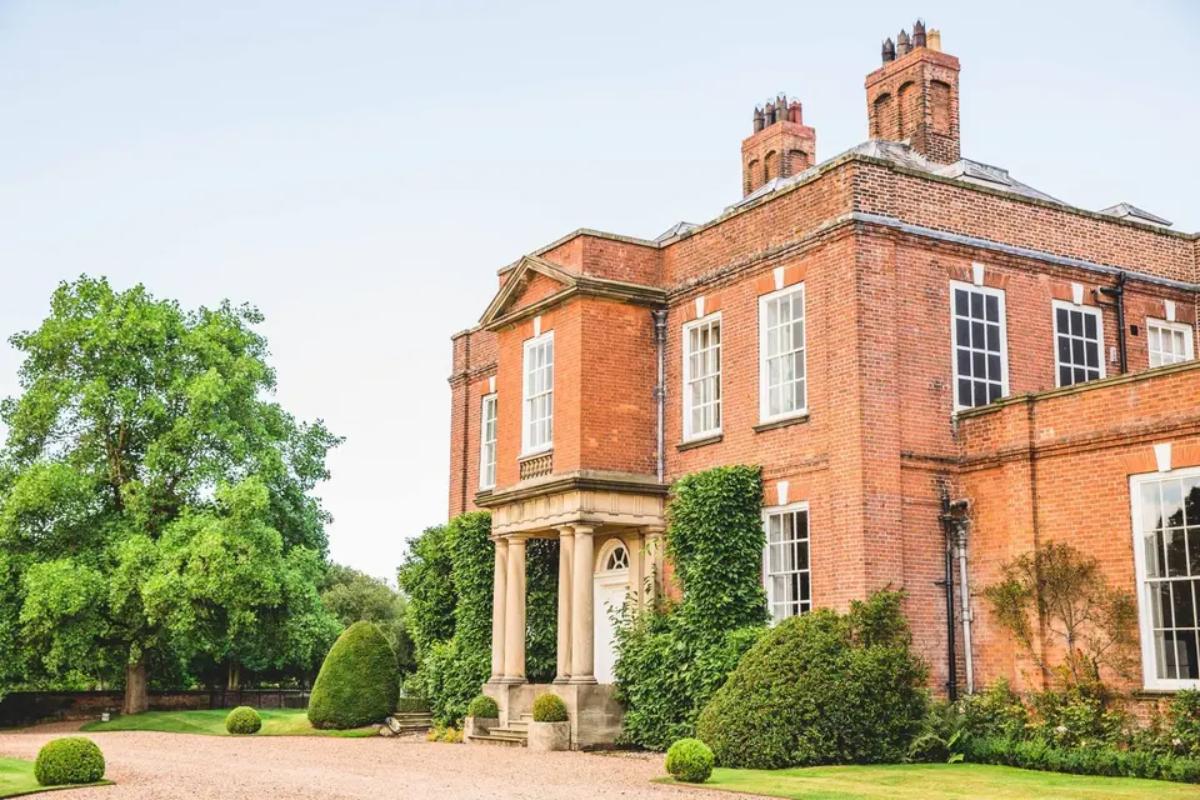 6 an outside view tothe side of weekend wedding venue Iscoyd park showcasing its grand entrance drive and greenery