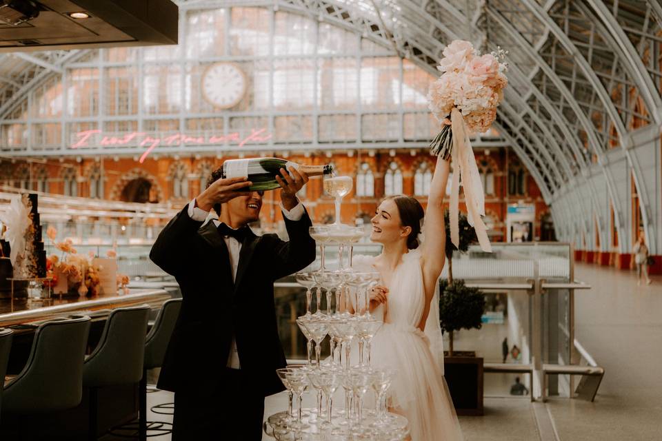 Image of couple of their wedding day, toasting with champagne 