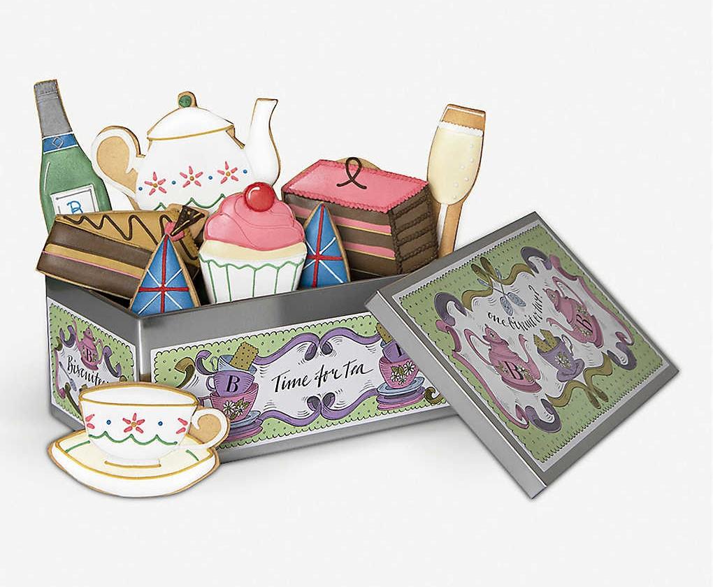 Biscuit tin featuring fun shaped biscuits such as a tea cup and cake