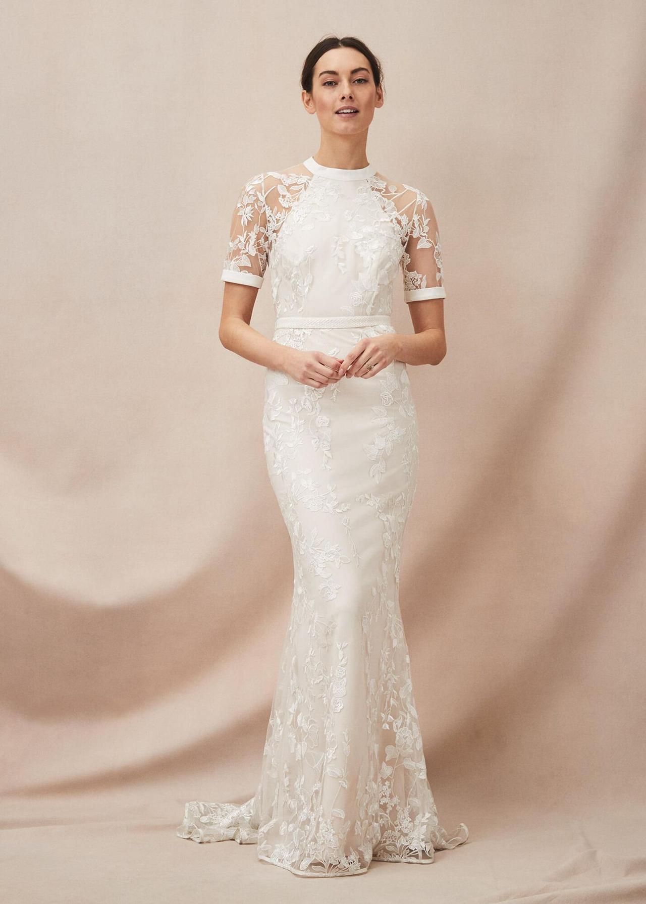 Model wearing a lace white wedding dress