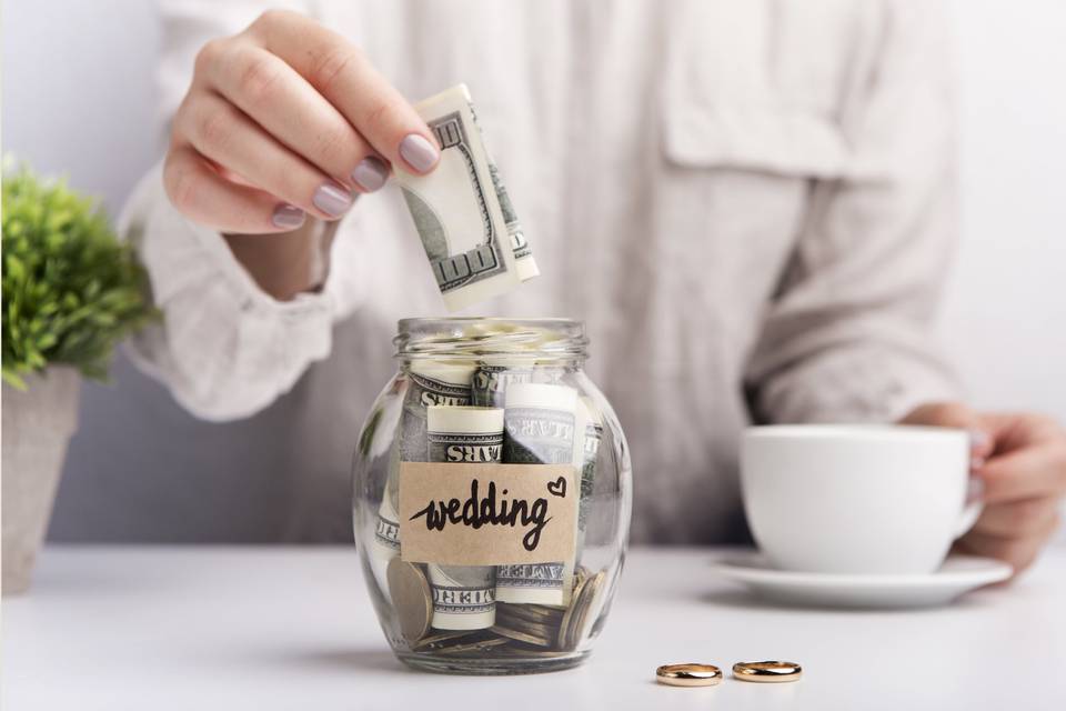 Money in a wedding budget pot