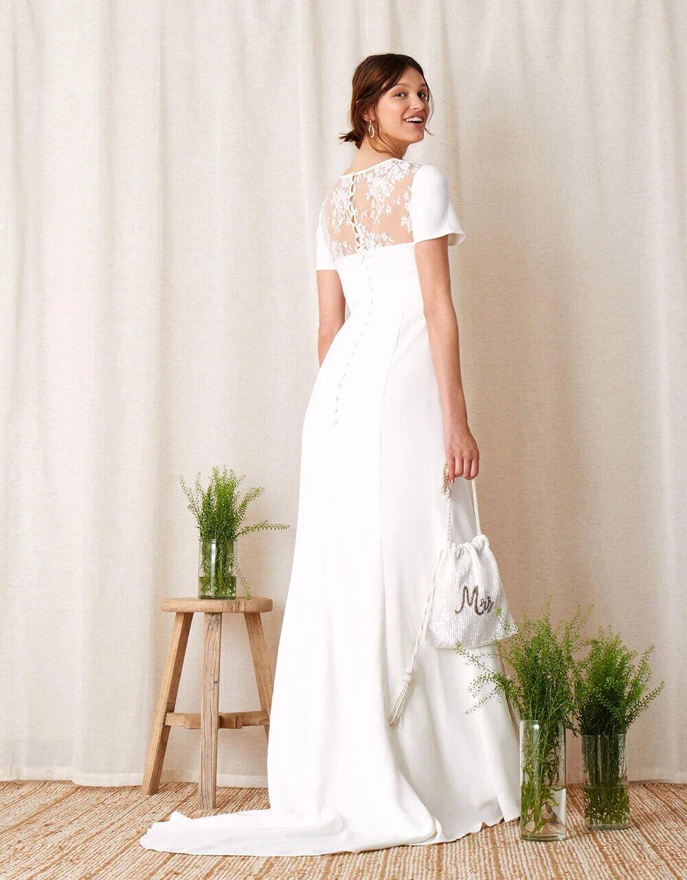 Model in a sleek wedding dress with lace panel 