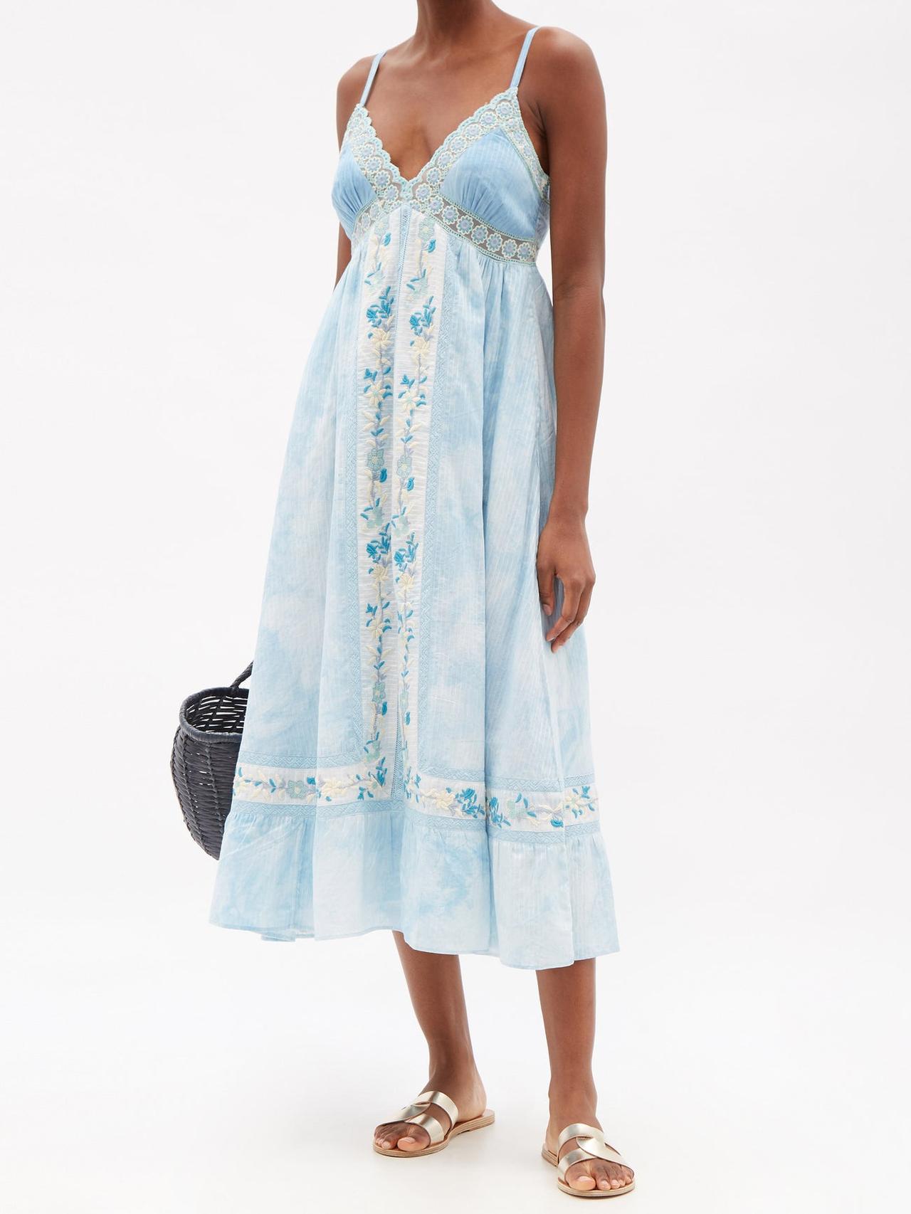 Image of a model wearing a midi blue tie dyed dress with embroidered details