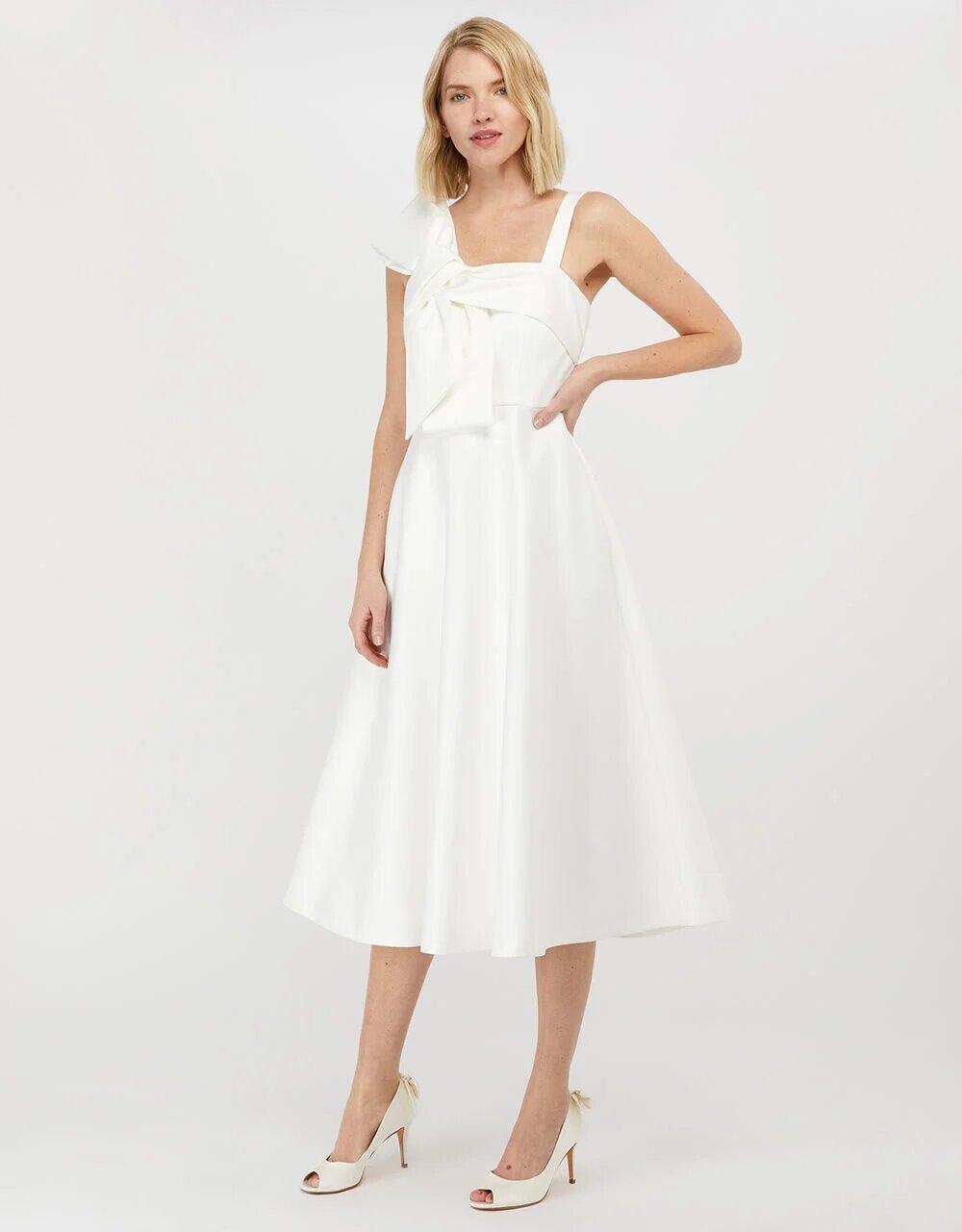Model wearing a white bow bridal dress
