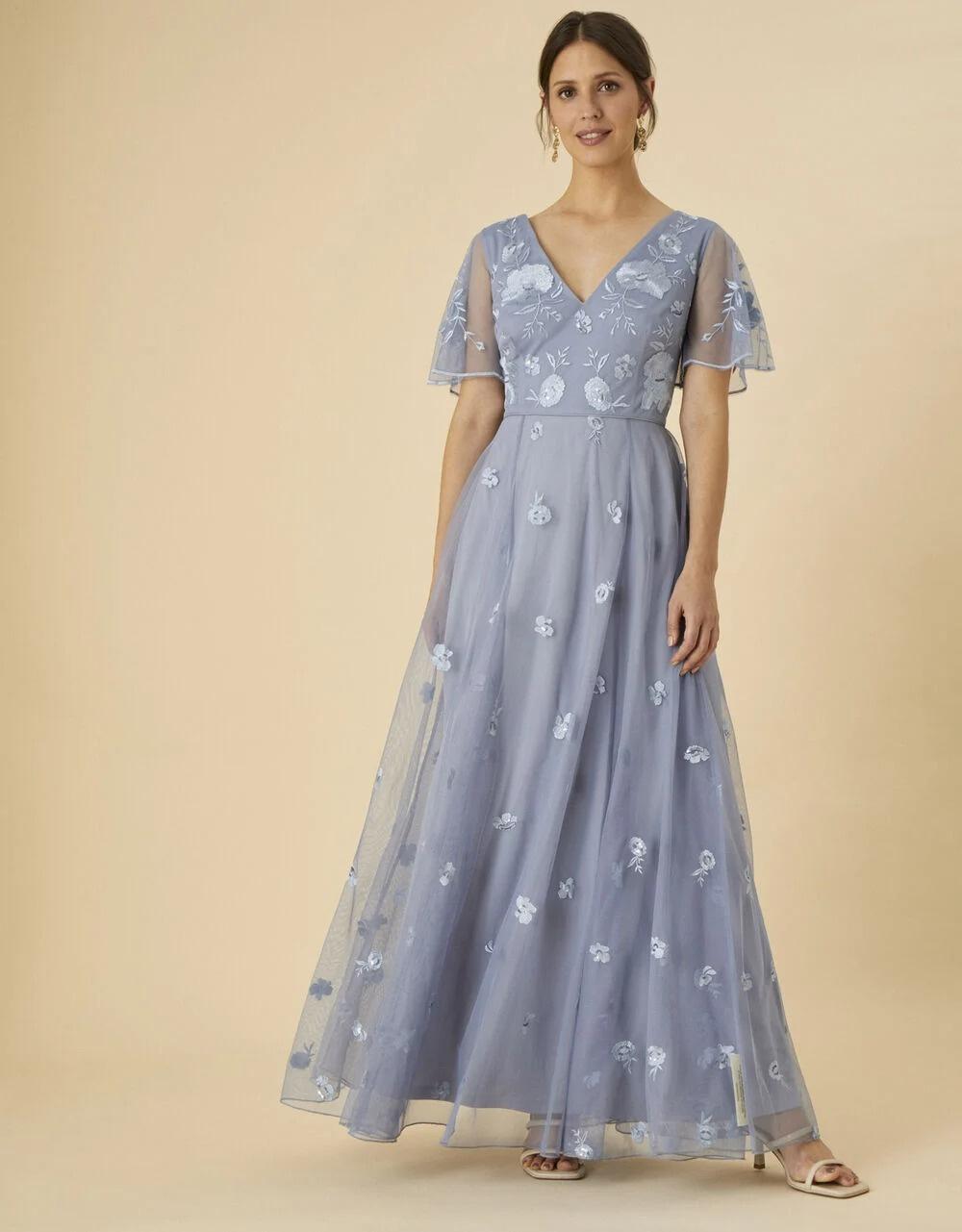 Model wearing an angel sleeve blue floral bridesmaid dress