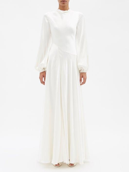Model wearing a high-neck long sleeve ankle length wedding dress 