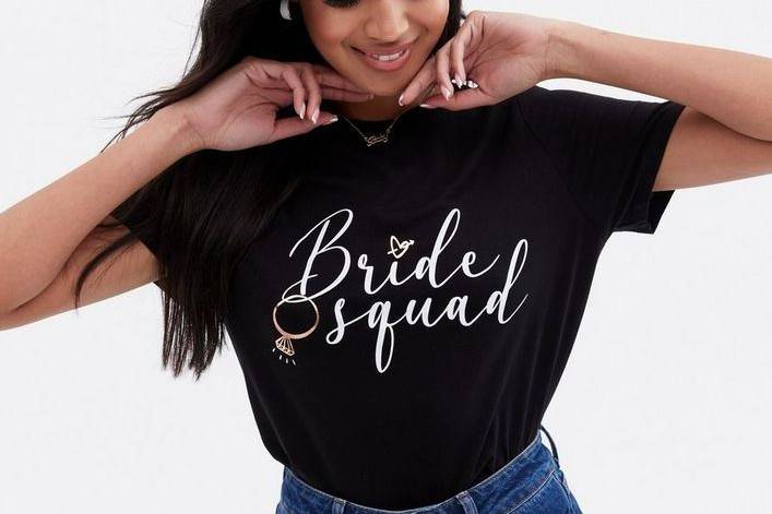 Model wearing a black 'bride squad' t shirt from New Look's new hen party collection