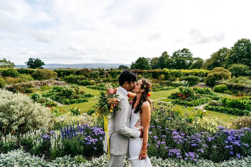 newlyweds kiss in the Hestercombe wedding venue gardens in a Somerset wedding venue