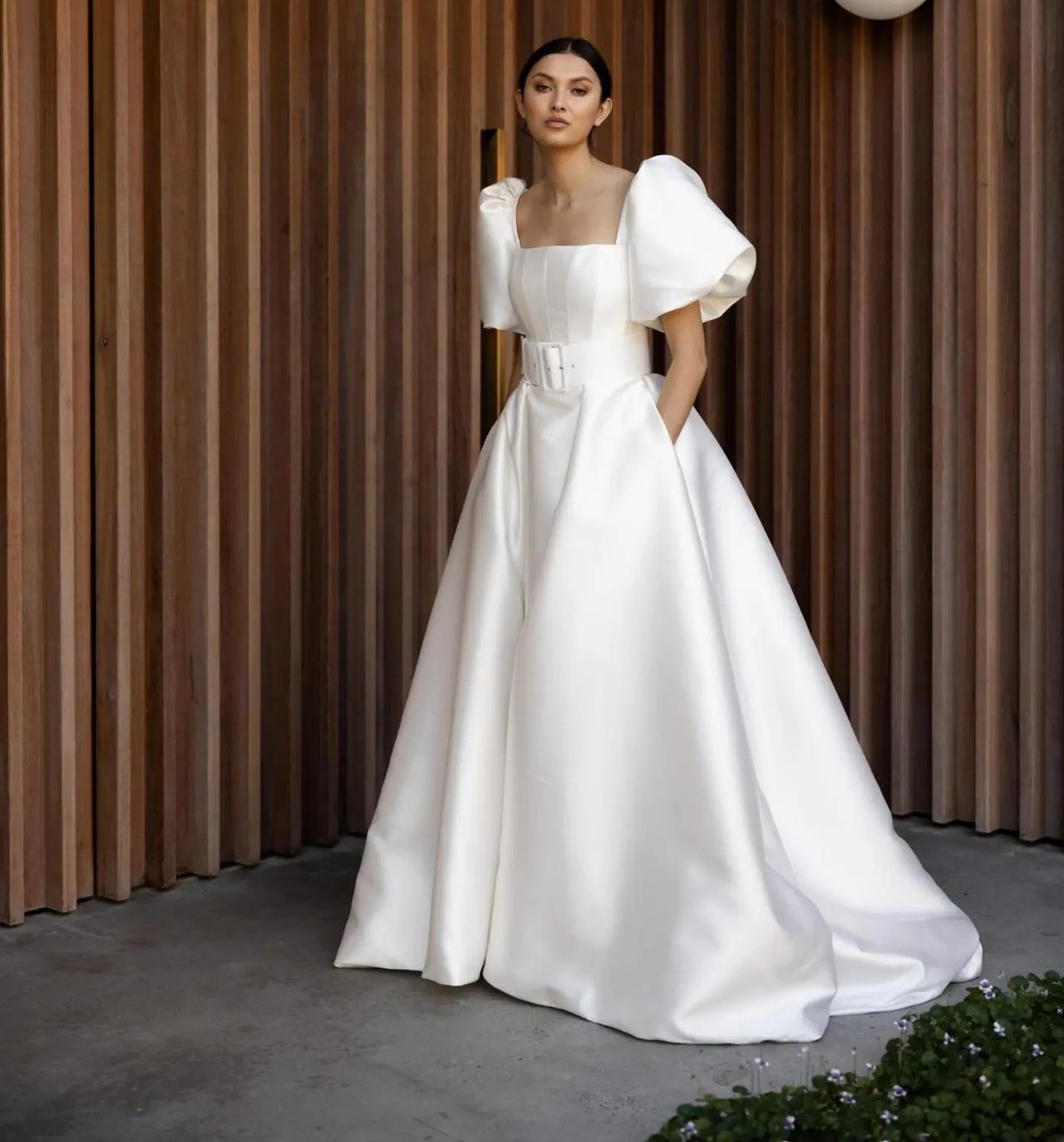 Model wearing a dramatic puff sleeve wedding dress