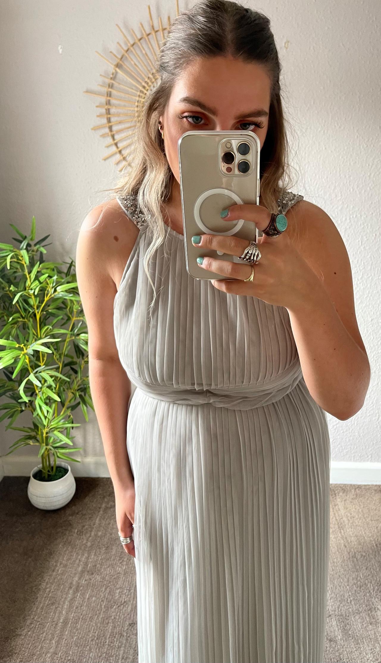 Model wearing a pleated maxi bridesmaid dress