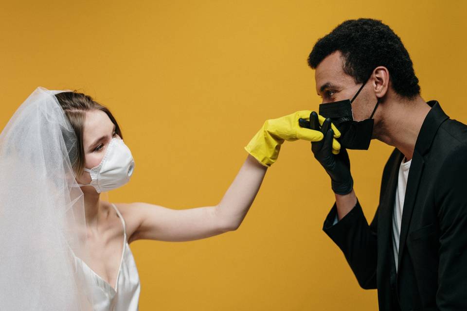 Bride and groom wearing face masks and rubber gloves