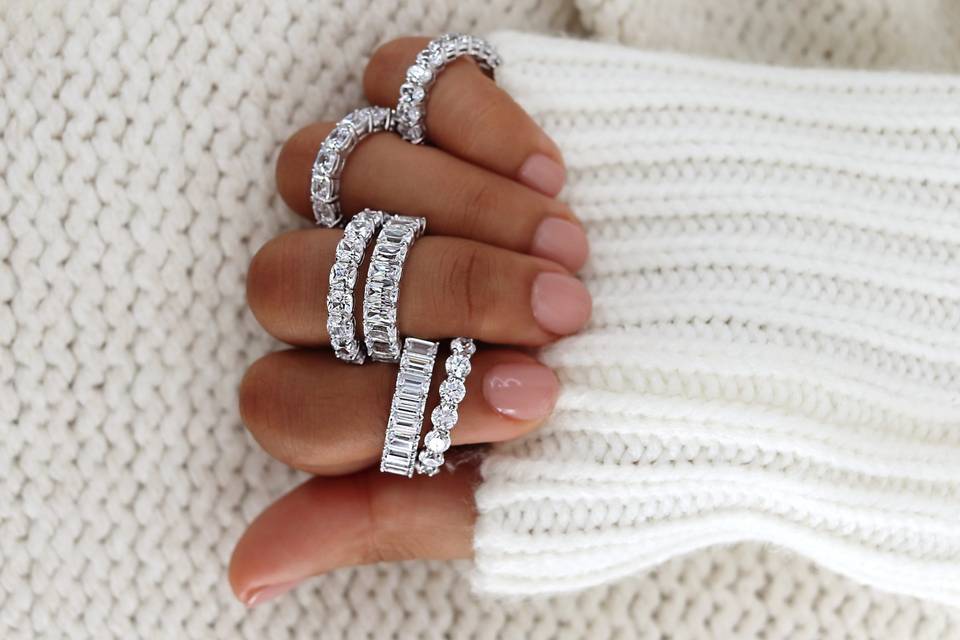 Person holding multiple stunning engagement rings all measured to fit their fingers