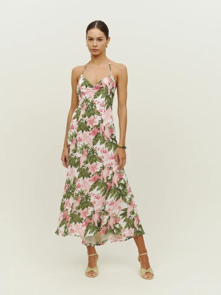 Model wearing a green and pink tropical floral bridesmaid dress