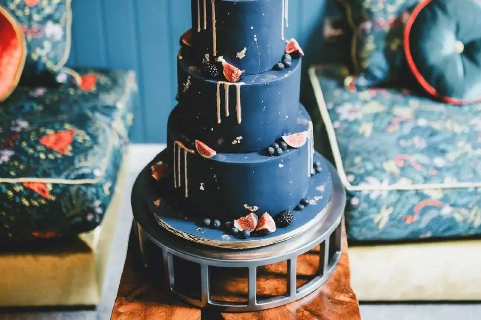 navy drip wedding cake with gold icing