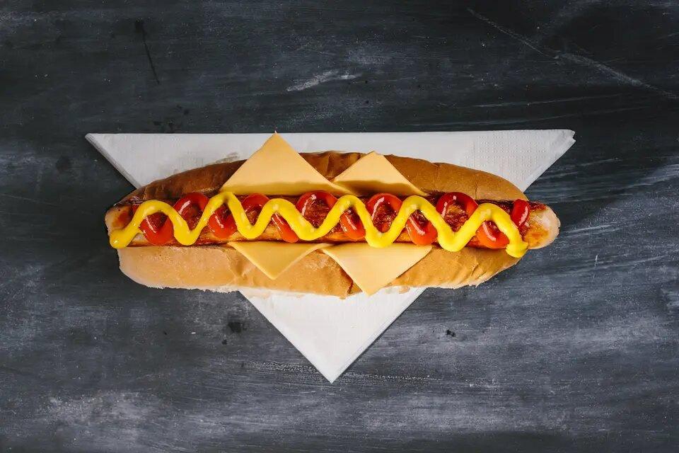 Hot dog with sauce and cheese