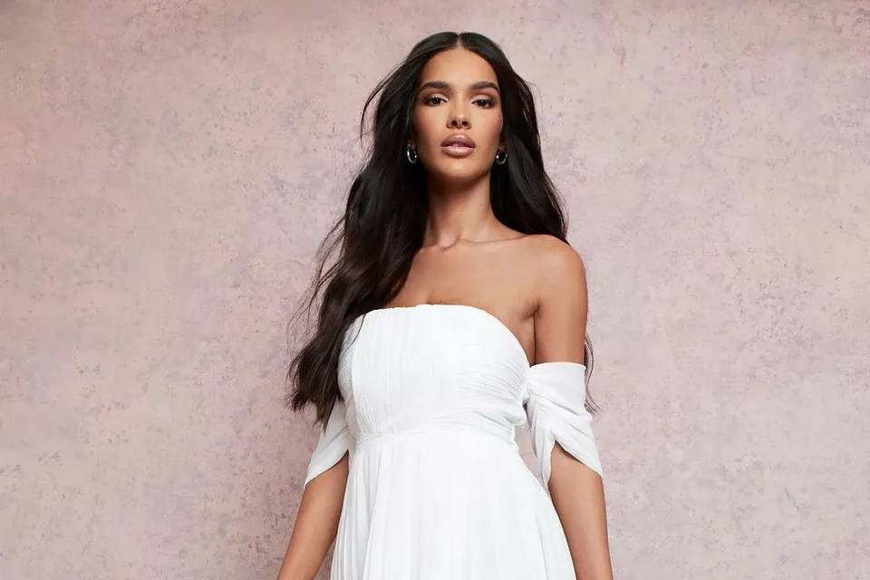 Model wearing an off the shoulder long white bridesmaid dress