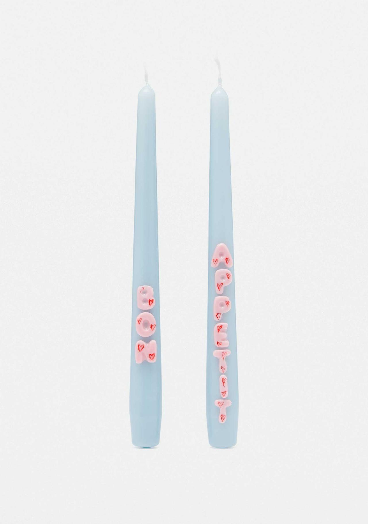 Two baby blue tall candles with Bon Appetite in light pink wax relief illustrated with red love hearts