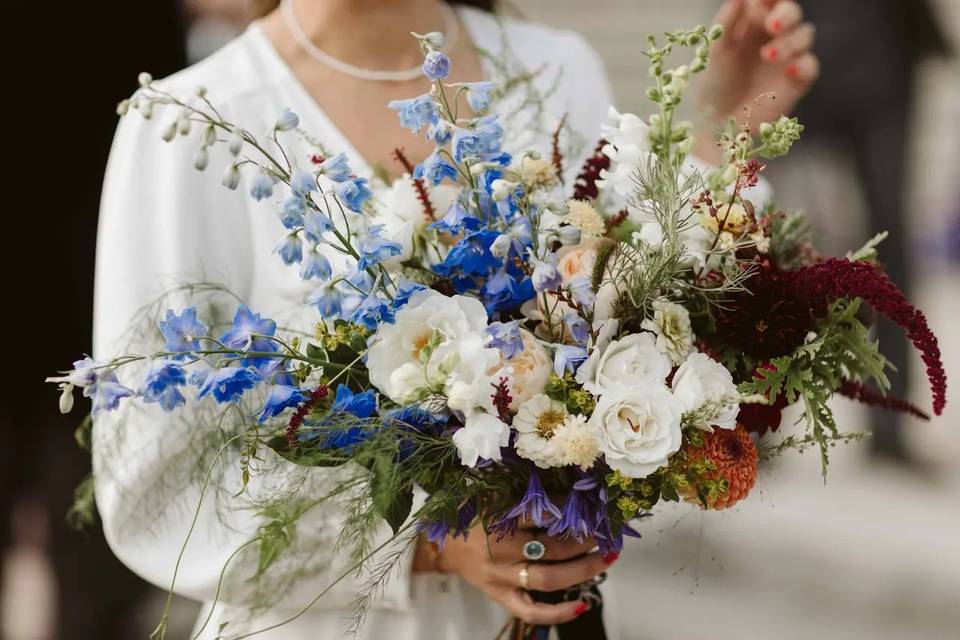 Bride holding a wedding bouquet with blue and white 