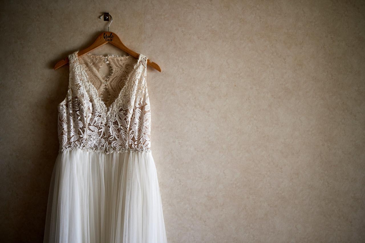 A wedding dress hanging on a wall