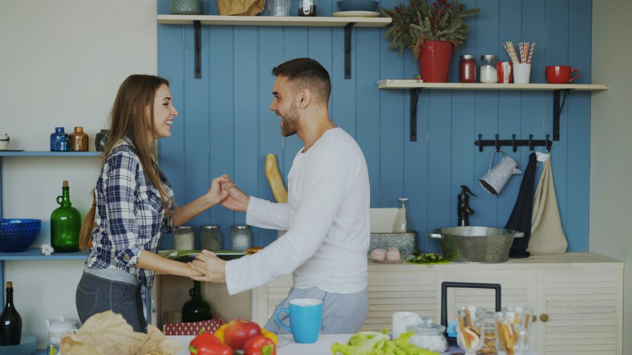 couple dancing together in kitchen