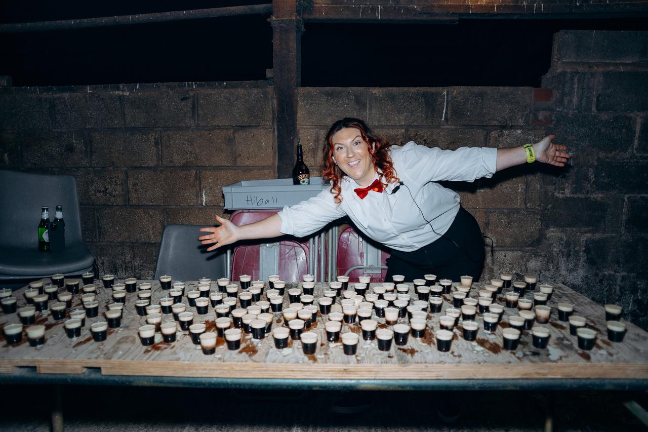 waitress in front of shots of baby guinness