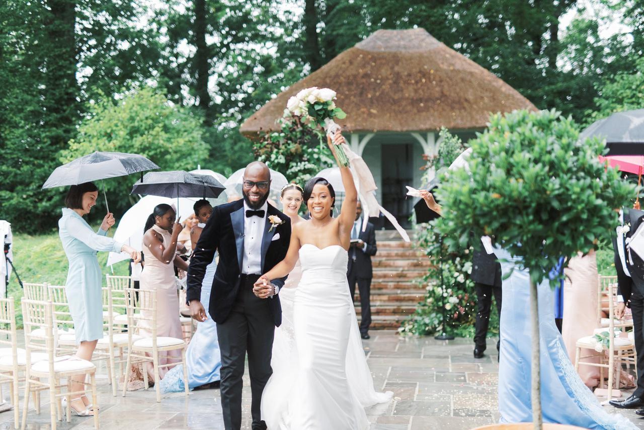 Newly married bride and groom walking up the aisle together