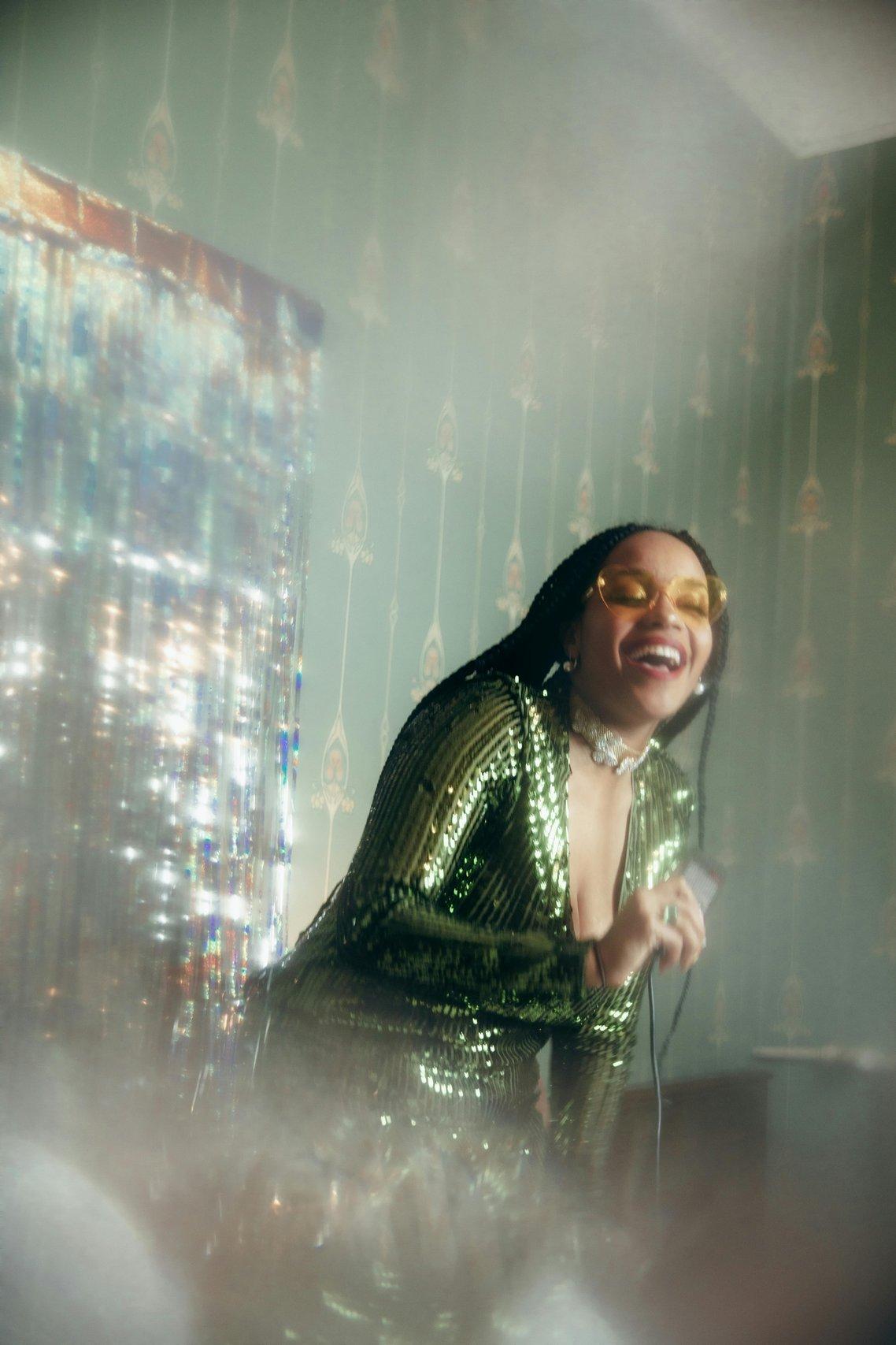 Woman singing at home with sparkly jumpsuit
