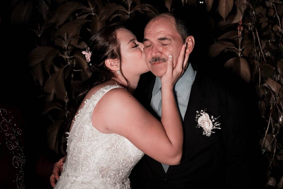 Grateful bride kissing her father on the cheek