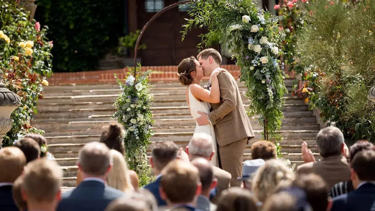 married couple kissing at altat