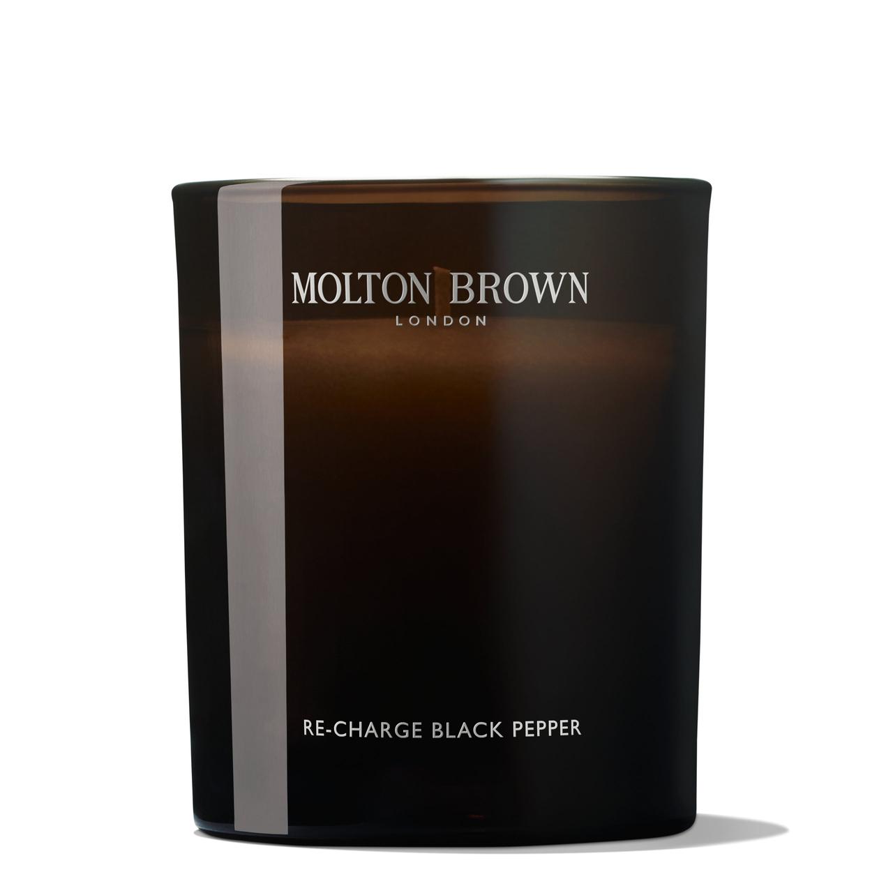 A large brown glass candle from Molton Brown described as having a black pepper scent.