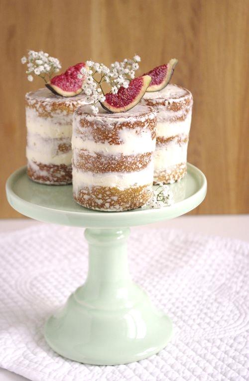 Individual semi naked rustic wedding cake topped with fruit and flowers