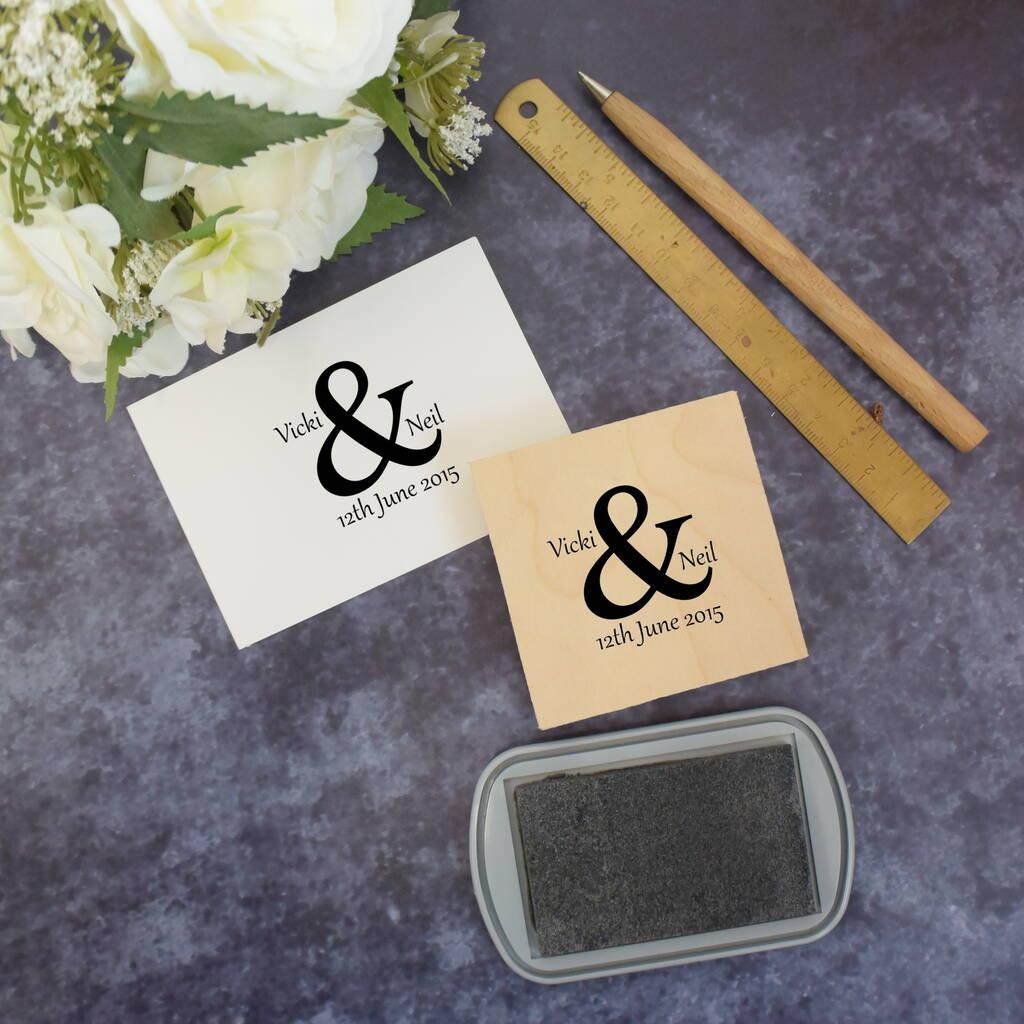 Two wedding stamps with a large ampersand between the couples' two names