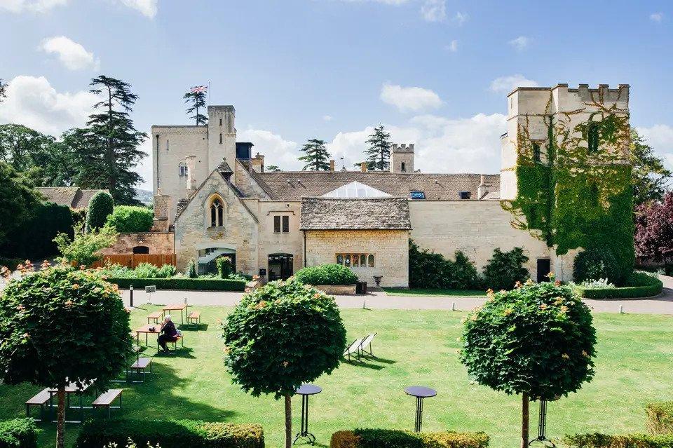 Outside shot of ellenborough park castle with lawn and trees