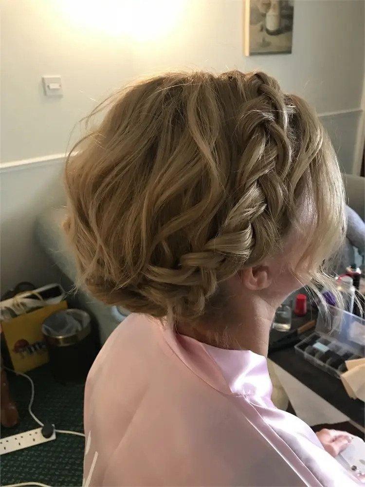 Back of a brides head with blonde hair in a milkmaid braid