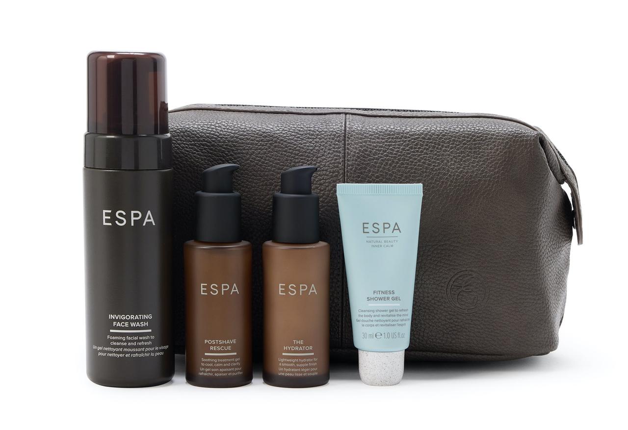 A leather grooming bag with four ESPA grooming products lined up in front as a gift idea for groomsmen.