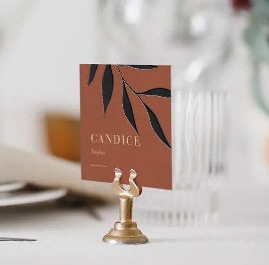 Sunset brown name card with black leaves and gold holder