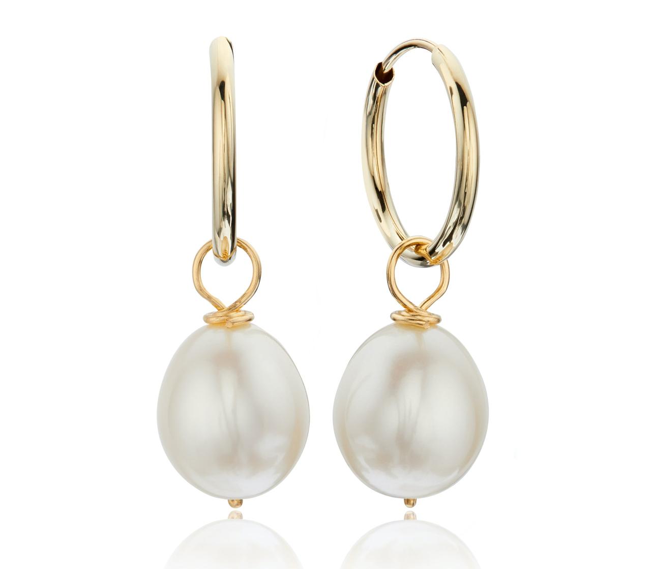 A pair of gold hoop earrings with freshwater pearls.