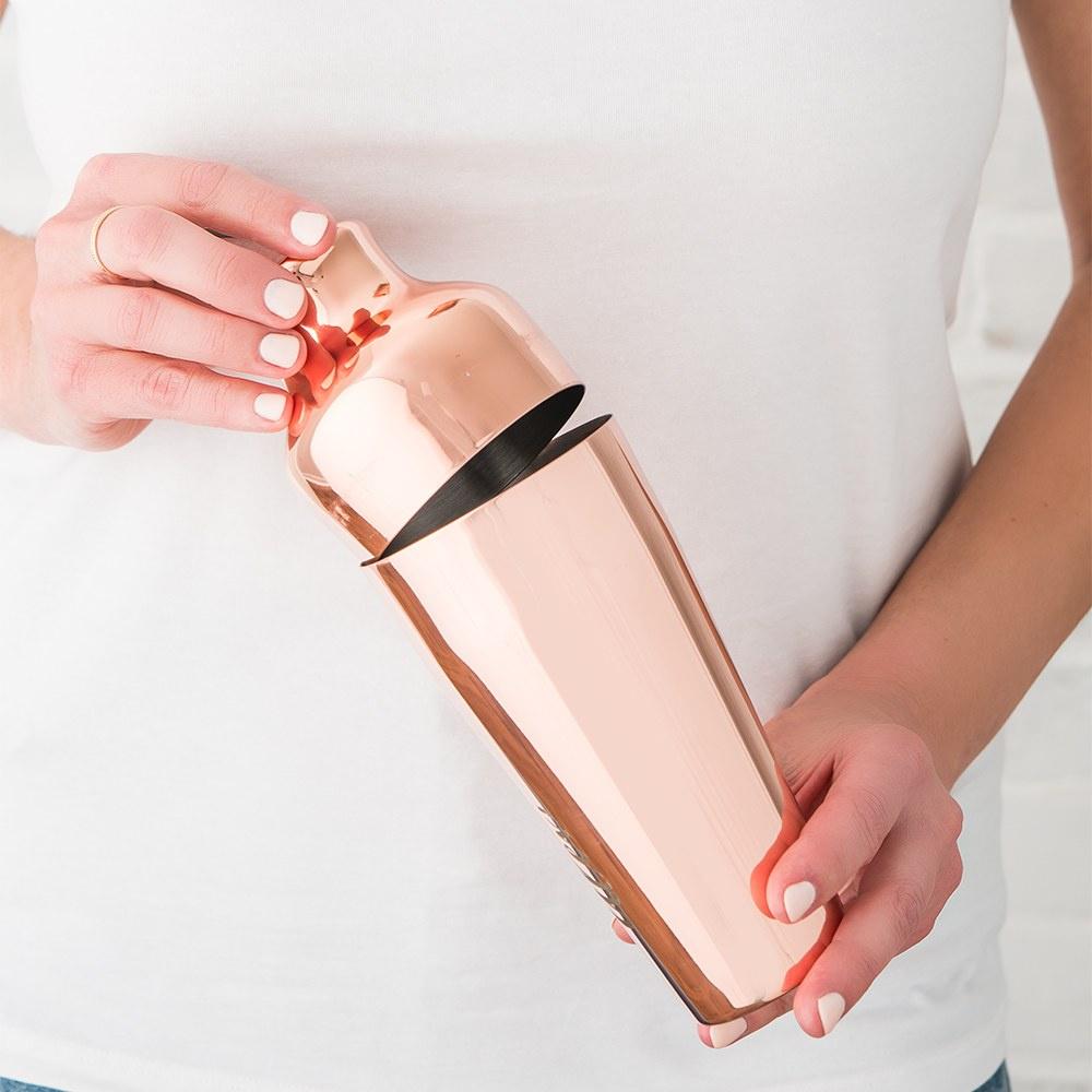 Girl holding a copper cocktail shaker