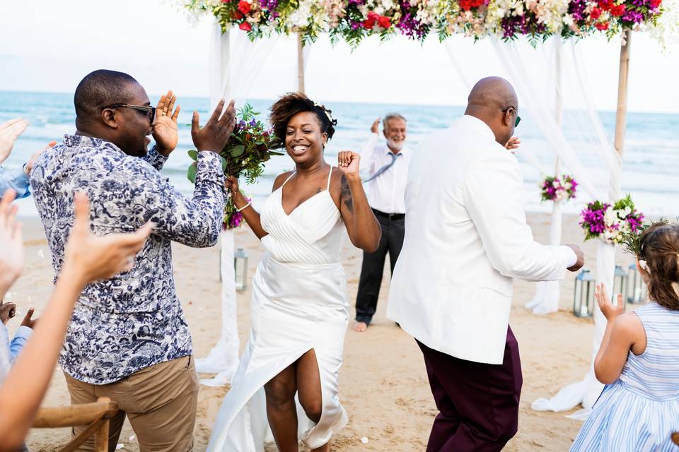 Wedding guests dancing on a beach