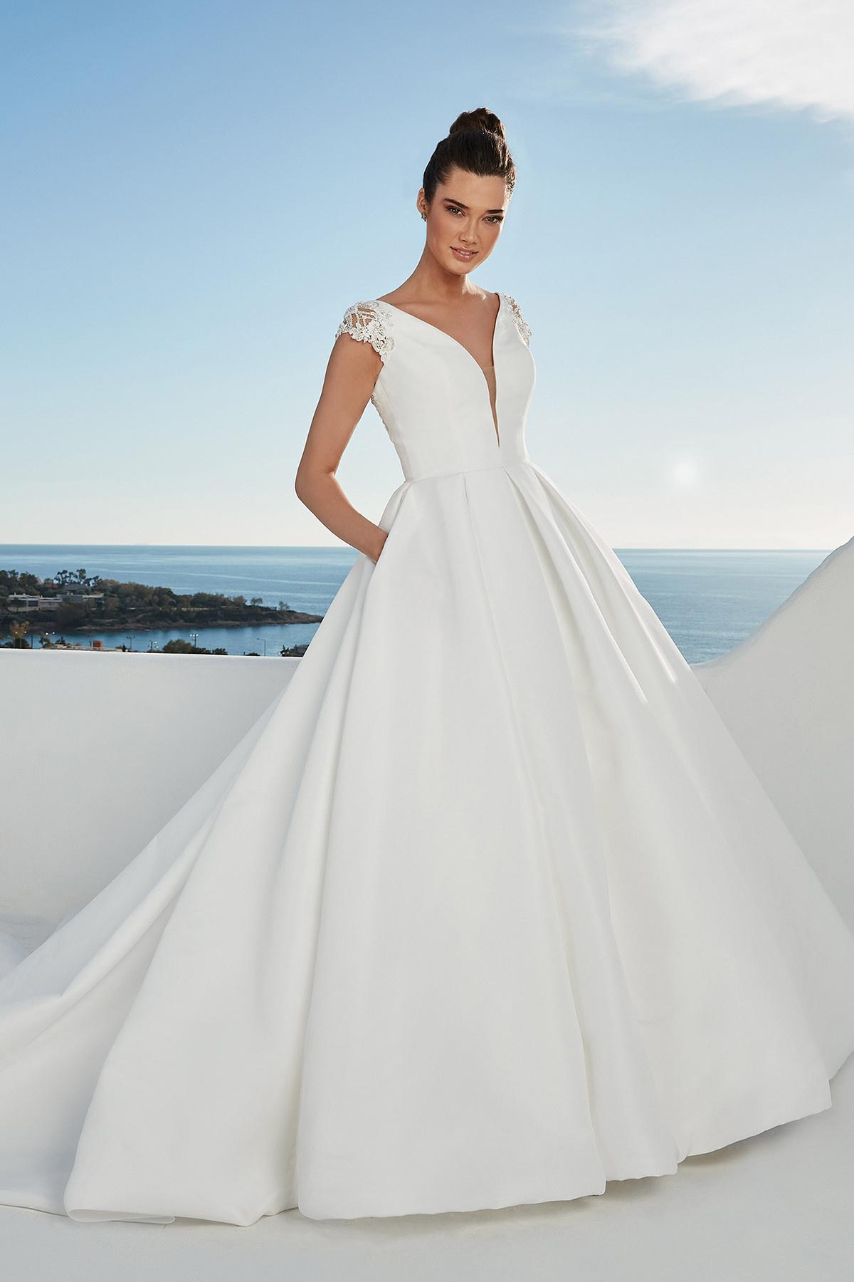 White Justin Alexander ballgown with lace shoulders and a plain skirt