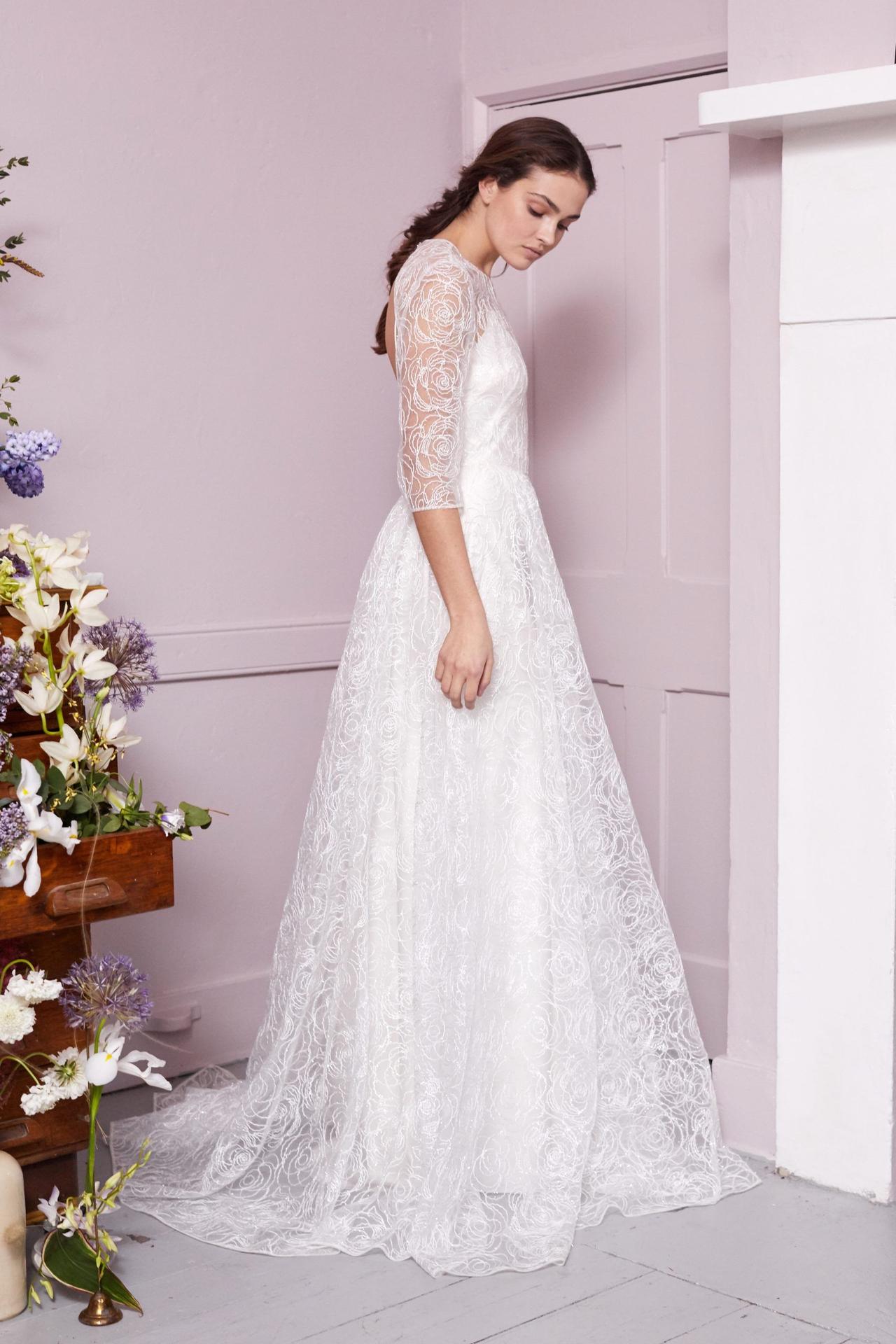 Model wearing a lace three quarter sleeve wedding dress