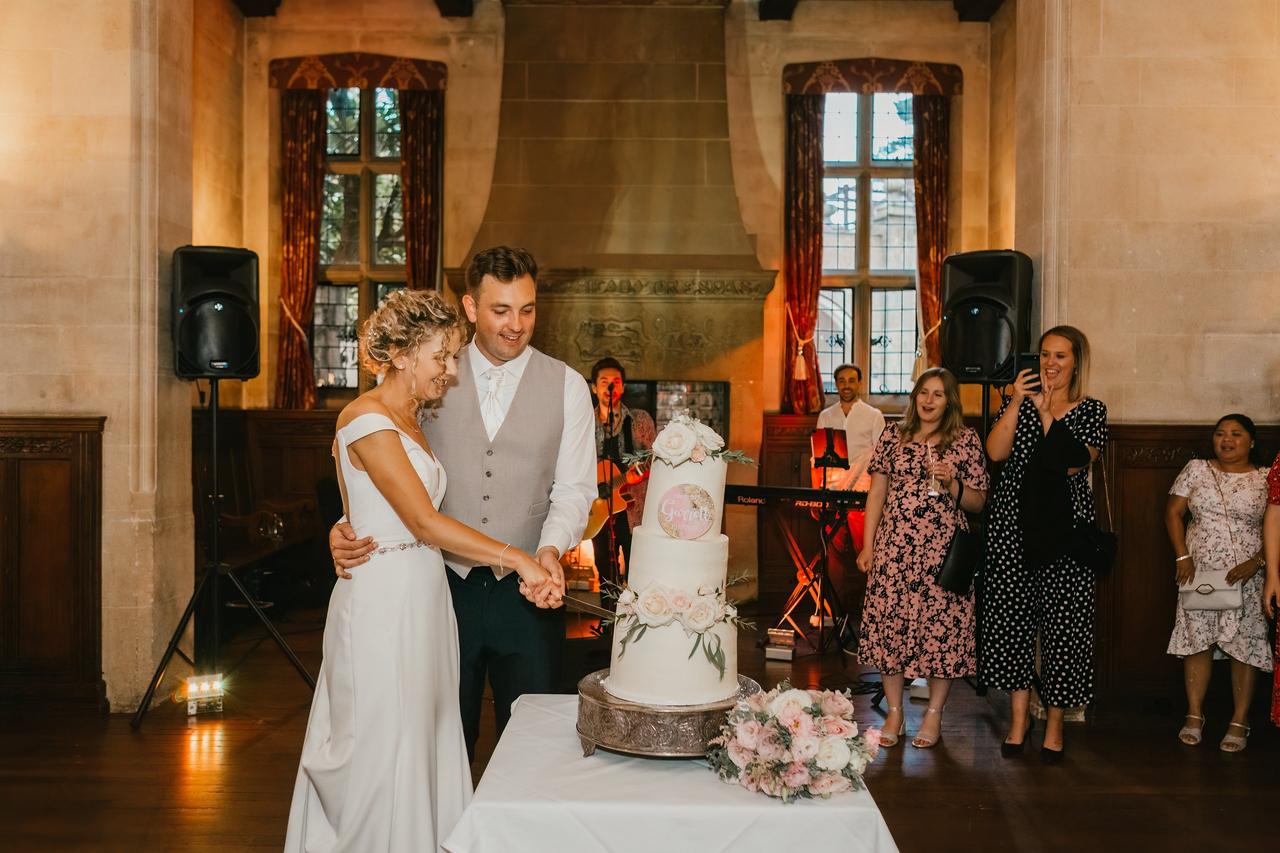 The bride and groom cut their wedding cake