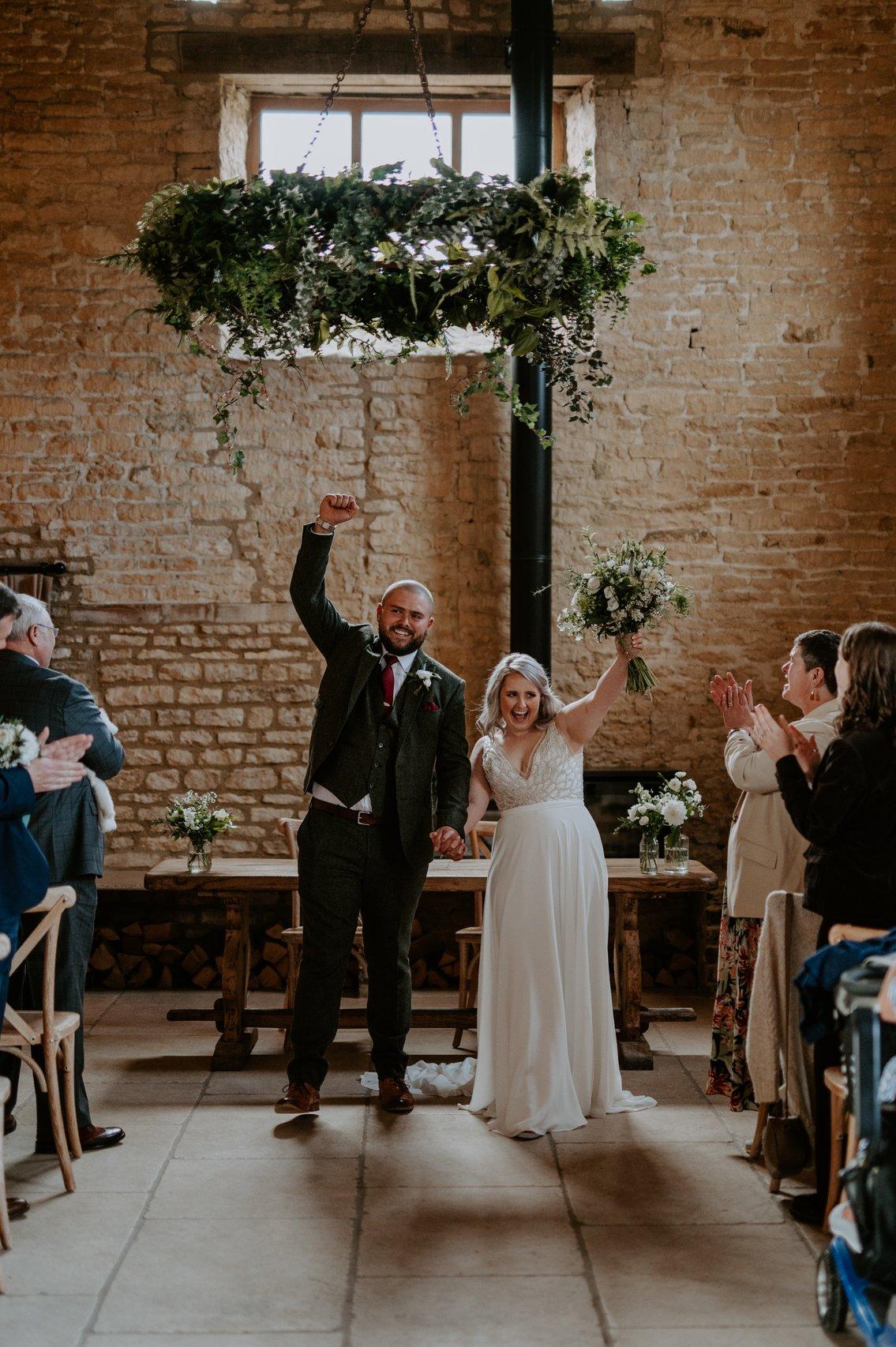 Sops and Sam excitedly punching the air as they're pronounced husband and wife