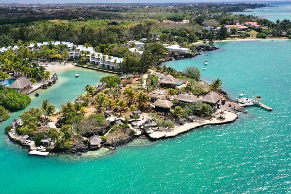 Honeymoon in Mauritius - An aerial view of the Paradise Cove Boutique Hotel located on an island surrounded by greenery and turquoise waters