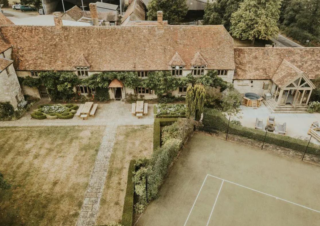 an aerial view of a wedding venue with gardens and a hot tub