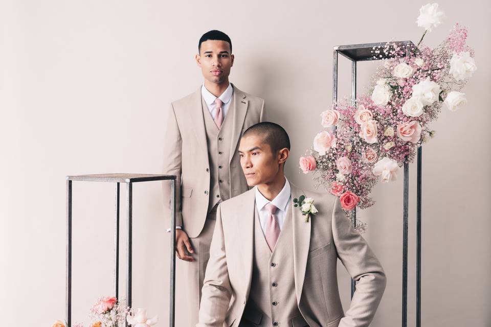 Two men in cream coloured wedding suits by Slater