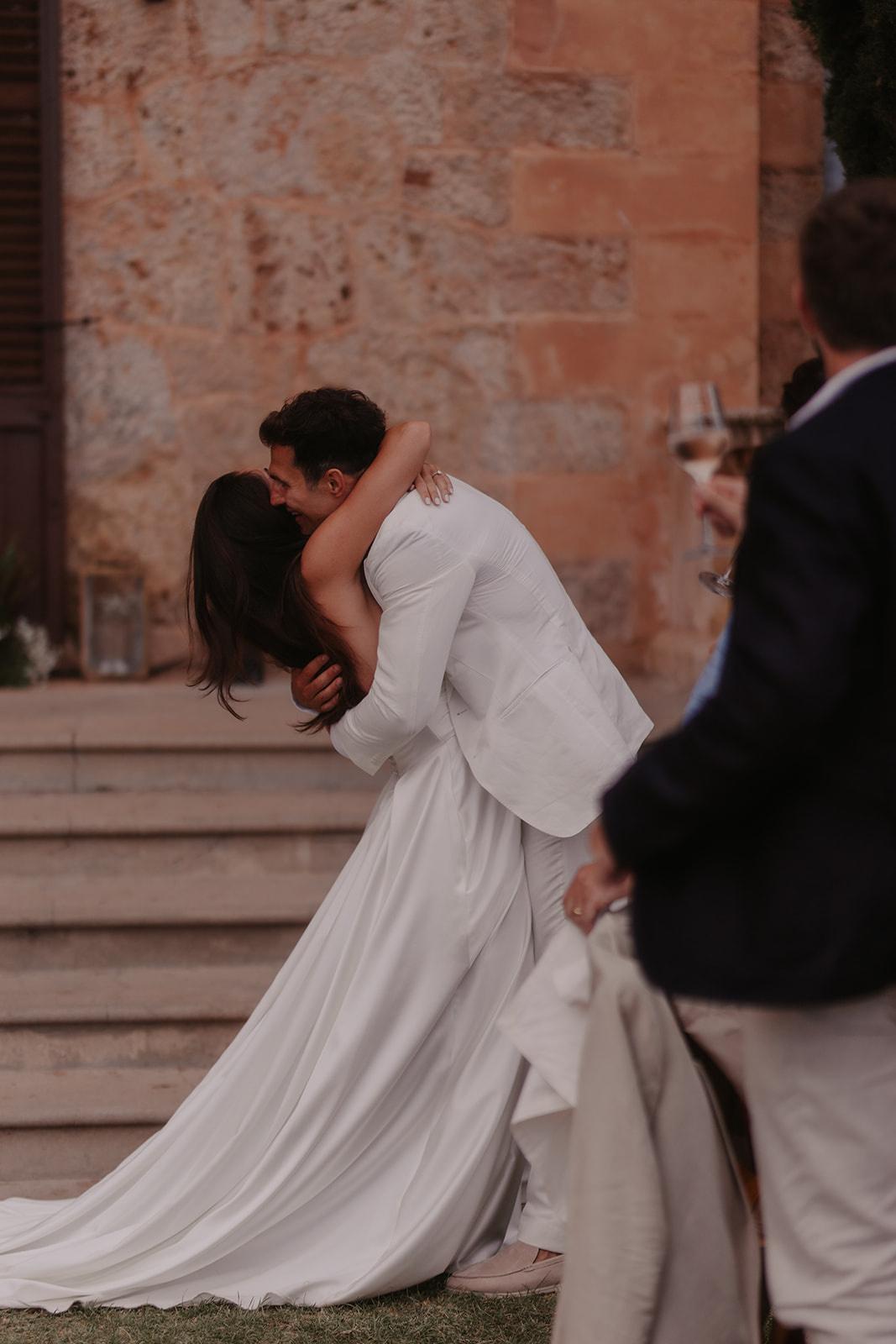 Josie and Cameron embracing at their wedding