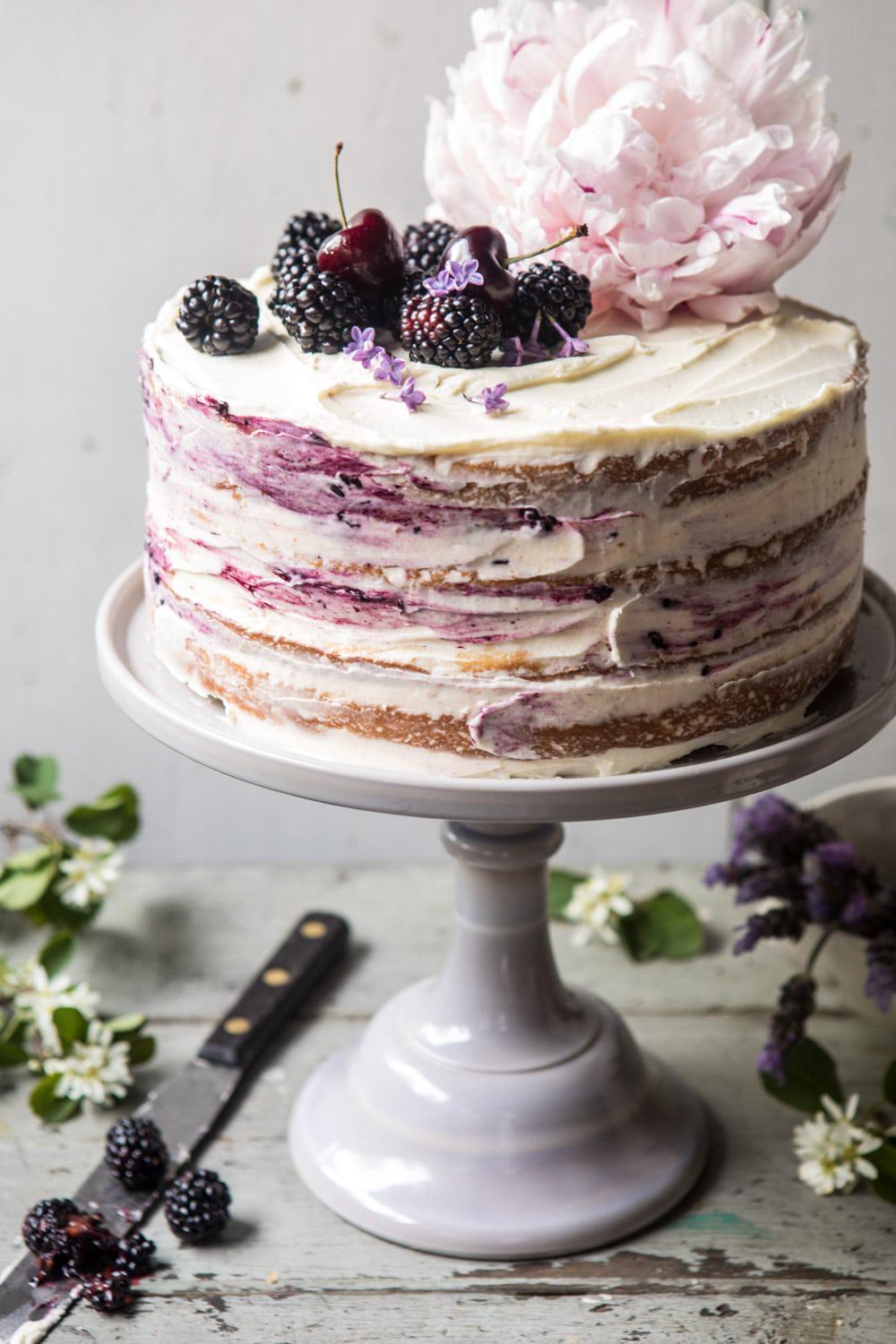 Semi naked rustic wedding cake with smears and blackberries