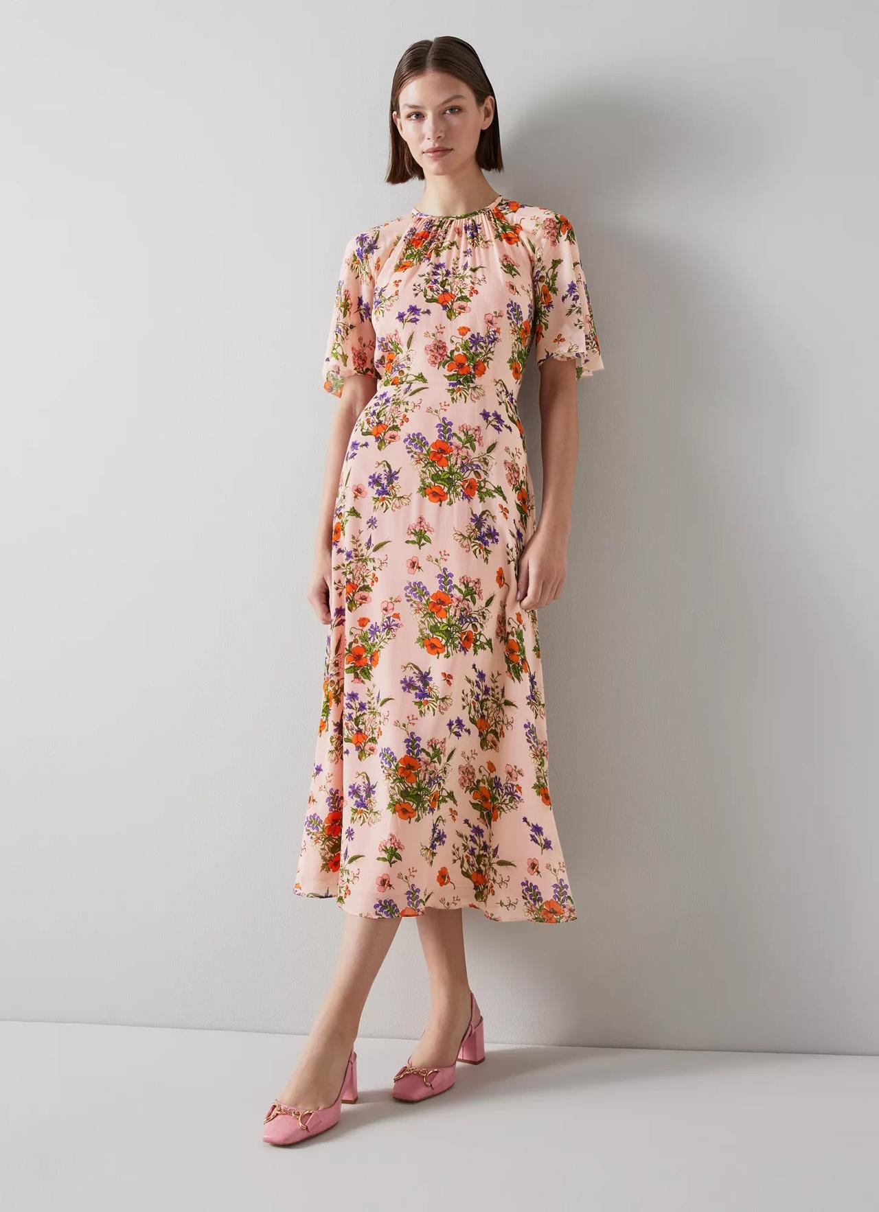 Model wearing a poppy print midi dress